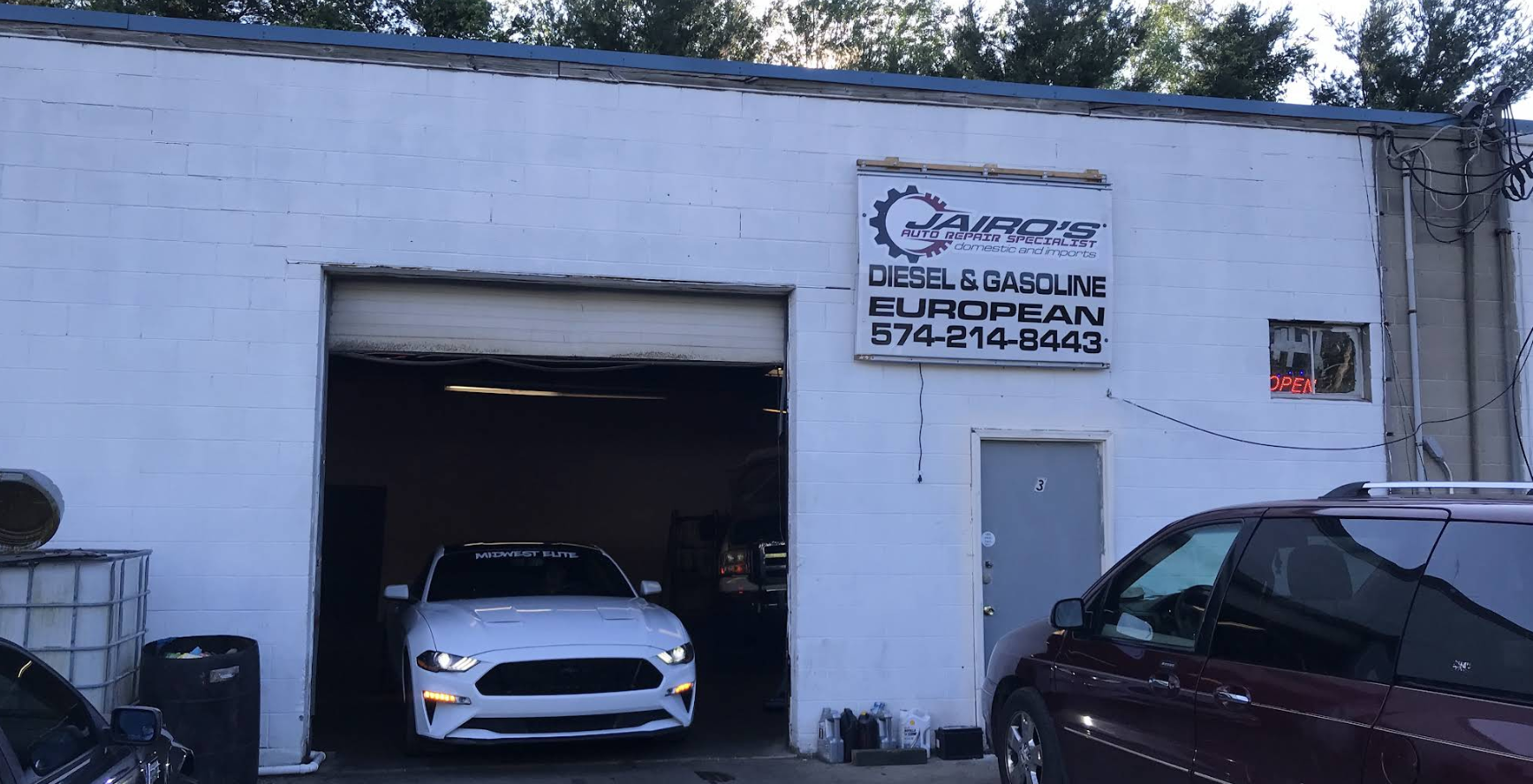 Jairo's Auto Repair Specialist garage bay with vehicles in Goshen, Indiana